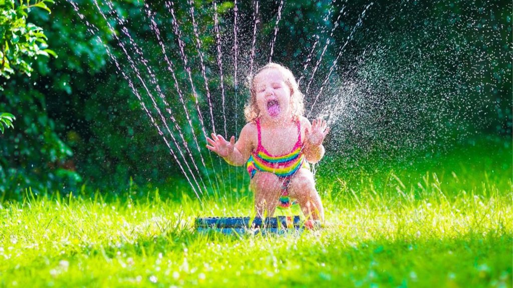 Water Your Lawn In The Summer Child Playing Sprinkler