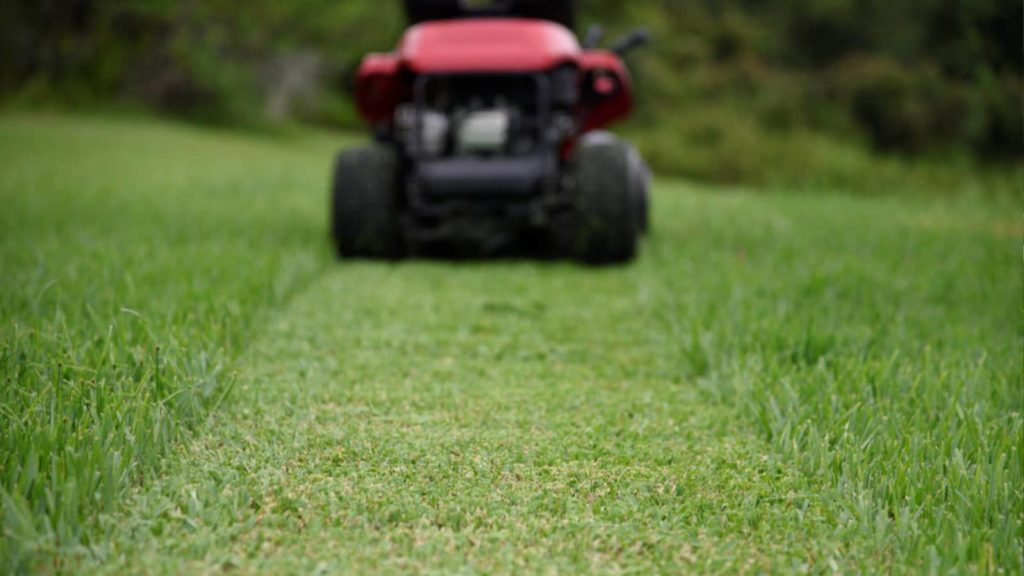 mowing grass with riding lawn mower